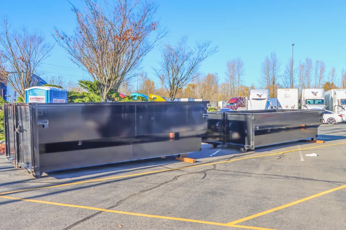Professional dumpster rental service with roll-off container on residential driveway in Yuma